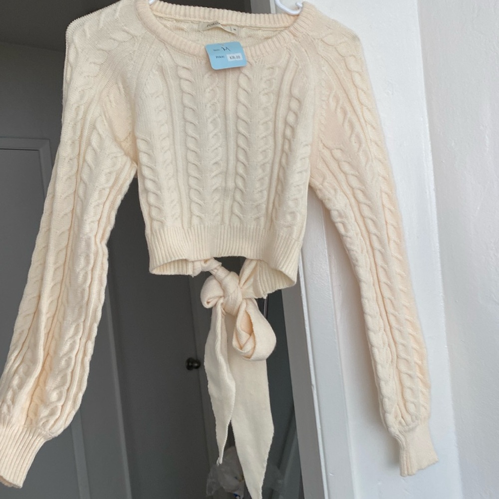 Cropped sweater with open back and tie.